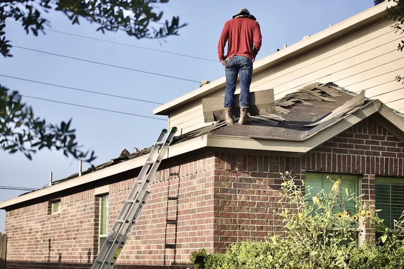 Professional roofer working on a residential roof in Capri Isles